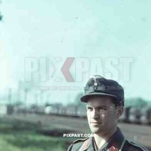 German Luftwaffe Ground Crew summer 1941 airbase with landing aircraft, portrait.