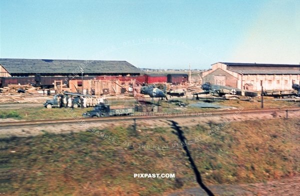 German Luftwaffe air plane repair workshop beside the train lines. Poland 1944 Bomber planes and wing parts being repaired