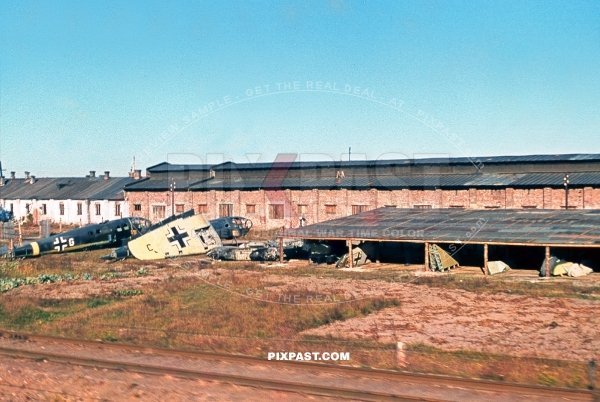 German Luftwaffe air plane repair workshop beside the train lines. Poland 1944 Bomber planes and wing parts being repaired