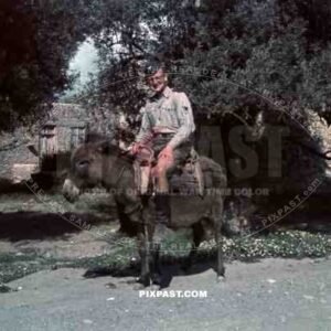 German Luftwaffe flak soldier riding donkey in Village, Kreta Crete 1942.