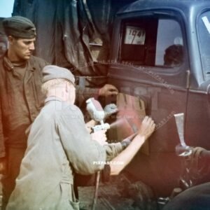 German Luftwaffe ground crew spray painting unit symbol on the door of a Opel army truck. Romania 1941