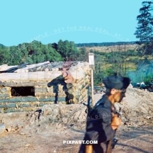 German Luftwaffe guard with Kar98 rifle guarding captured Russian wood timer pillbox bunker. Ukraine summer 1942