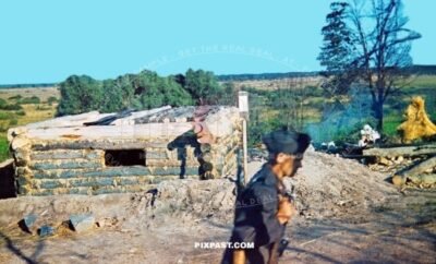 German Luftwaffe guard with Kar98 rifle guarding captured Russian wood timer pillbox bunker. Ukraine summer 1942