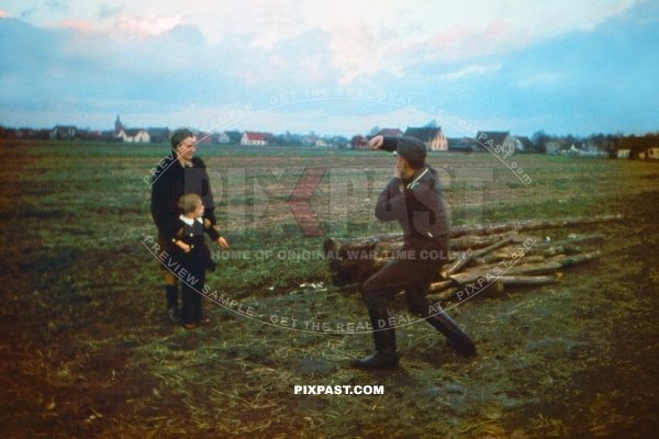 German Luftwaffe soldier photographing his son and wife in Leipzig 1942. Using a Leica camera in field.