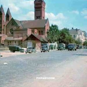 German Luftwaffe unit Luftlotte 2 drive past the Red Church / Church of Saints Simon and Helena in Minsk Belarus 1941.
