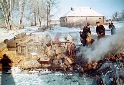 German Panzer No. 3 sunk in Russian winter snow. Panzer soldiers starting fire to melt the snow. Russia winter 1942
