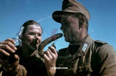 German War Photographer Fritz Moosmueller eats german sausage in Tunisia 1942. 90th Light Infantry Division.