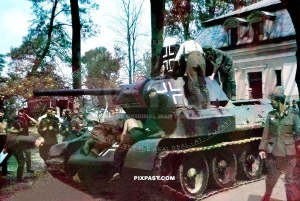 German Wehrmacht Beutepanzer T34 being repaired and repainted with Balkan cross. Stalingrad area 1942.