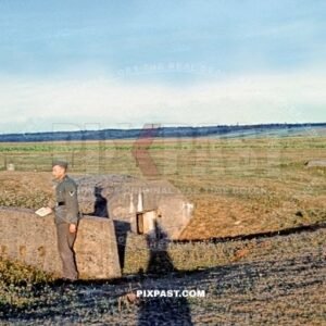 German Wehrmacht Gefreiter inspecting small infantry machine-gun bunker in Netherlands field 1940