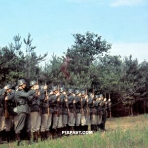German Wehrmacht soldiers presenting arms Kar98 rifle in front of unit officer. France 1940