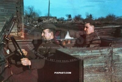 German Wehrmacht staff driver driving his commanding officer in a Volkswagen Kubelwagen. Chernihiv Ukraine 1943