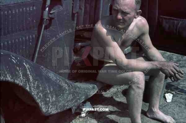 German army driver resting beside Mercedes Staff car on Dusty Russian Roads. Summer 1941. 4th Panzer Division.