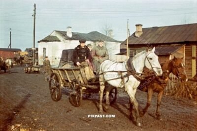 German army officer in kradmelder rubber uniform collected from train station in Russian horse carriage. Russia 1942.