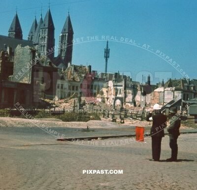 German army soldier talking with Local Belgium fire brigade officer Notre-Dame de Tournai Cathedral Tournai, Belgium 1940