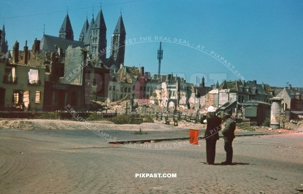 German army soldier talking with Local Belgium fire brigade officer Notre-Dame de Tournai Cathedral Tournai, Belgium 1940