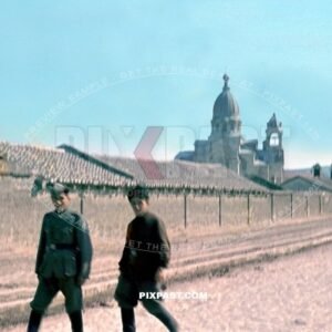 German army soldier walking with Russian Cossack in uniform and boots. Ukraine village 1942