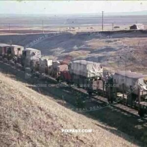 German army transport train in Russia 1944. White wash army trucks towards the front.