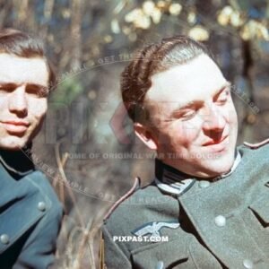 German artillery officer resting with Kradmelder Motorbike Messenger in rubber rain jacket.Russia 1942. 8th Panzer Division