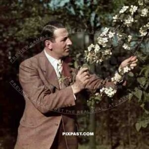 German gentlemen in suite and tie inspecting flower garden in Frankfurt 1939. War time agfacolor film.