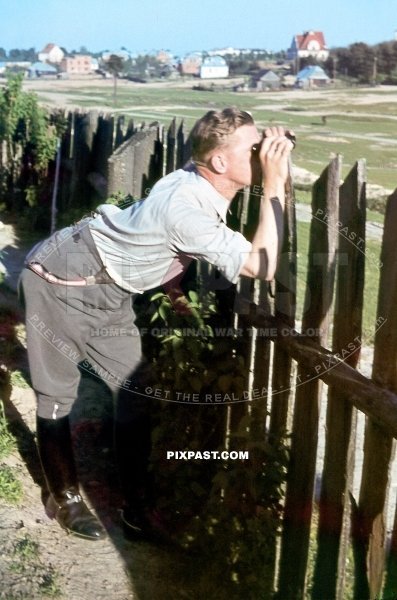 German infantry officer using his field binoculars in France 1940. 297 Infantry Division.