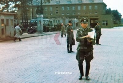 German panzer training officer inspecting log book in front of mini turretless training panzer 1 tanks in front of garage 1940