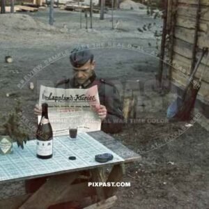 German soldier reading propaganda newspaper Lappland Kurier about the Dieppe Raid August 1942.