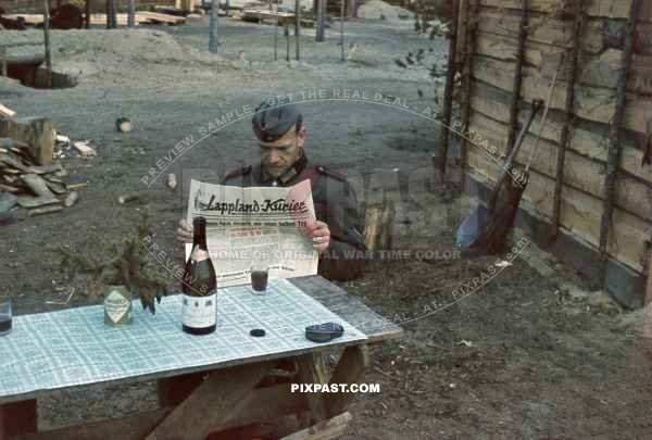 German soldier reading propaganda newspaper Lappland Kurier about the Dieppe Raid August 1942.