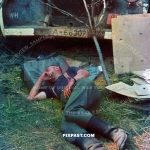 German soldier sleeping beside army Opel truck. Painting road traffic signs. Russia 1942. A-66307