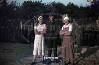 German soldier with local village women, 10th Motorised infantry division repair werkstatt Bryansk 1941, binoculars,