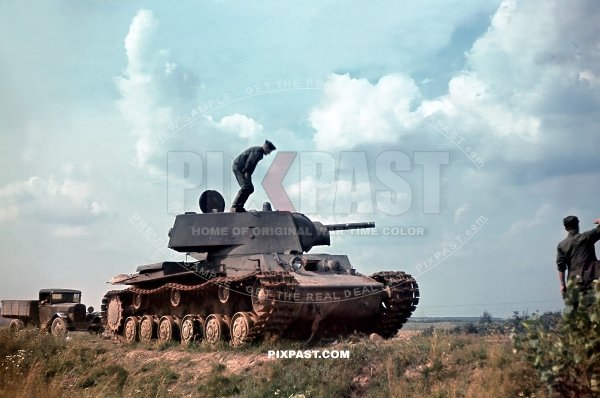 German soldiers climbing on a Kliment Voroshilov KV1 Heavy Russian tank for inspection. 19th Panzer Division Russia 1941