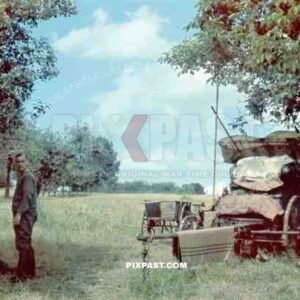 German soldiers resting beside horse drawn wagon in French orchard 1940