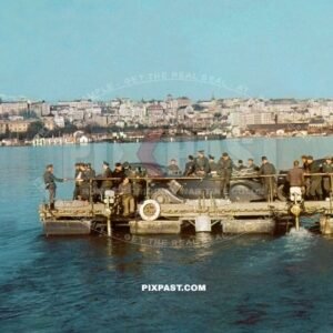 German staff cars and army personnel transported on army ferry across lake in Belgium 1940.