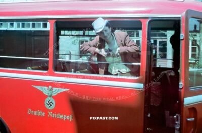 German women in full costume inside a red Deutsche Reichspost Bus. Munich Bavaria Germany 1940