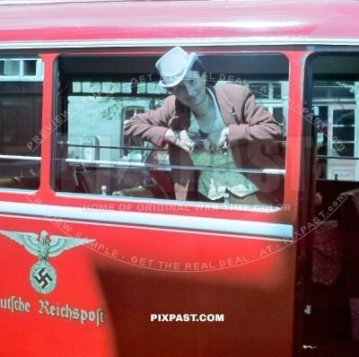 German women in full costume inside a red Deutsche Reichspost Bus. Munich Bavaria Germany 1940