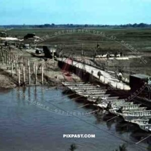Germany army supply trucks driving over a make-shift pontoon bridge on the river Bug. 94. Infantry Division. Russia 1941