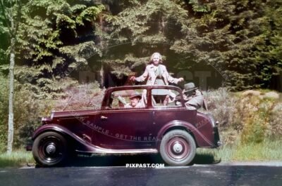 Germany family with red car from Rheinprovinz go on summer holiday 1938. Idar Oberstein. the Felsenkirche.