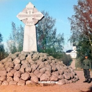 Granite memorial cross erected in 1894 on the site of Korsholm Castle in Old Vaasa Finland 1942. German soldier on the right