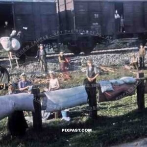 Gypsies freed from a German transport train, collect bed material from American GIs. Bischofshofen  Austria 1945