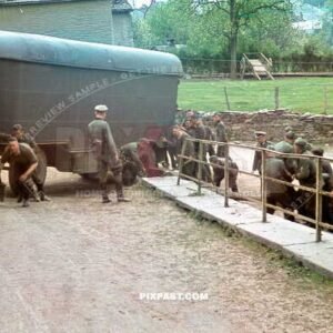 Heavy German Wehrmacht supply truck with trailer in France 1940. Soldiers helping push the trailer around bend.
