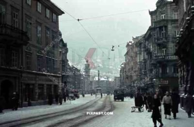 Innsbruck, Austria, 1939, Winter Snow, Maria Theresien Strasse, cars, trucks and bus, Alps in the background.