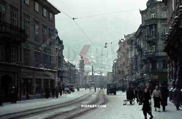 Innsbruck, Austria, 1939, Winter Snow, Maria Theresien Strasse, cars, trucks and bus, Alps in the background.