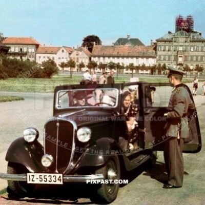 Italian Fiat Balilla 1937 cabrio IZ-55334 parked on street in Western Germany 1937. Soldier in dress uniform.