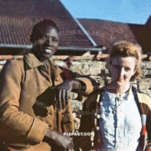 Ivory Coast colonial French infantry soldier captured. German occupation of France 1940. Farmer wife with colorful jumper