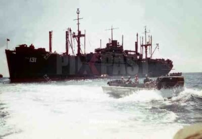 Landing craft returning to load more soldiers from troop transport PA 131. Coast of Okinawa 1945