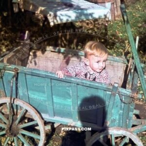 Little boy playing in his blue Bollerwagen in Munich Bavaria Germany 1940