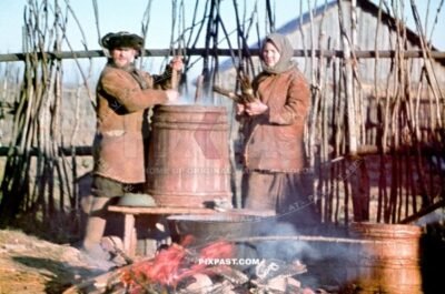Local Russian farmers preparing warm soup over an open fire for their village on the outskirts of Smolensk Russia 1942
