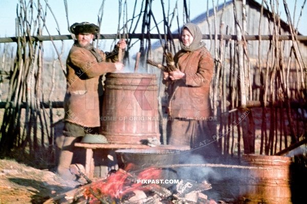 Local Russian farmers preparing warm soup over an open fire for their village on the outskirts of Smolensk Russia 1942