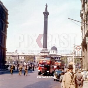 London Red Bus in front of Nelsons Column. Whitehall road. London England 1944. War time.