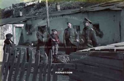 Mariupol Ukraine 1942, German army officers play with local children in farm