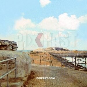 Massive military artillery bunker on the French coast. Colorful camouflage and sand bags and netting. France 1940